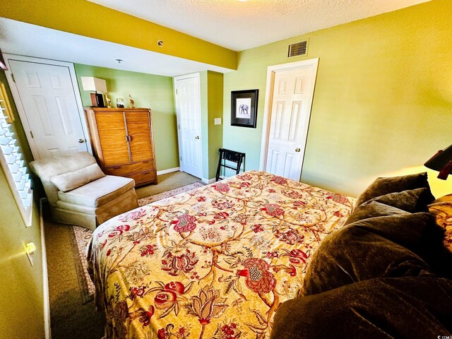 bedroom with light carpet and a textured ceiling