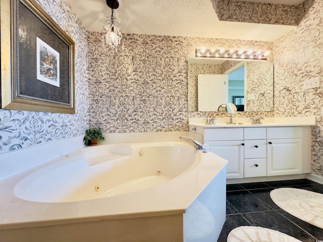 bathroom with vanity, tile patterned flooring, a washtub, and a textured ceiling