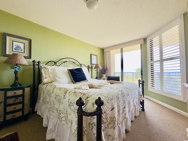 carpeted bedroom featuring a textured ceiling