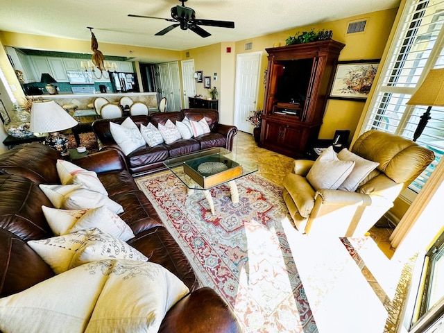 living room with ceiling fan and plenty of natural light