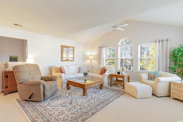 living room featuring a textured ceiling, carpet flooring, lofted ceiling, and ceiling fan