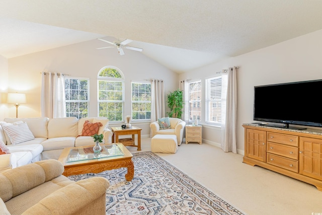 carpeted living room with vaulted ceiling and ceiling fan