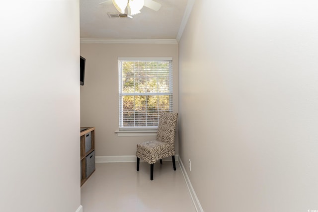living area featuring ceiling fan and ornamental molding
