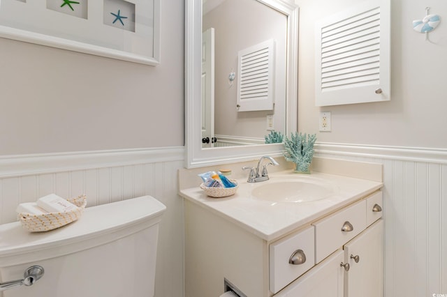 bathroom featuring toilet and vanity