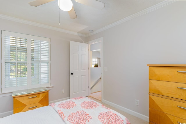 bedroom featuring ceiling fan, ornamental molding, and multiple windows