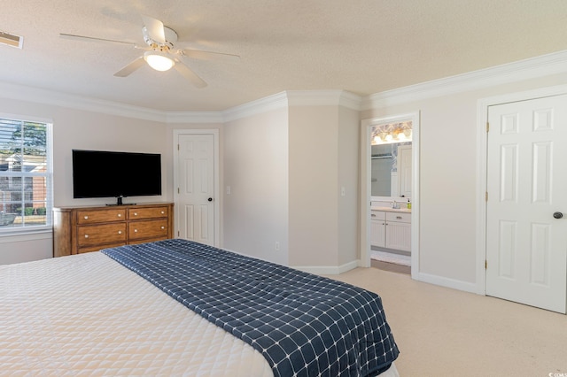 carpeted bedroom featuring ceiling fan, connected bathroom, crown molding, and a textured ceiling