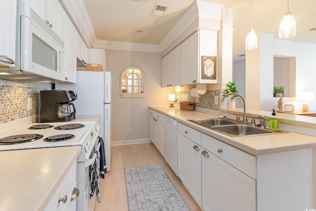 kitchen featuring sink, backsplash, white appliances, and white cabinets