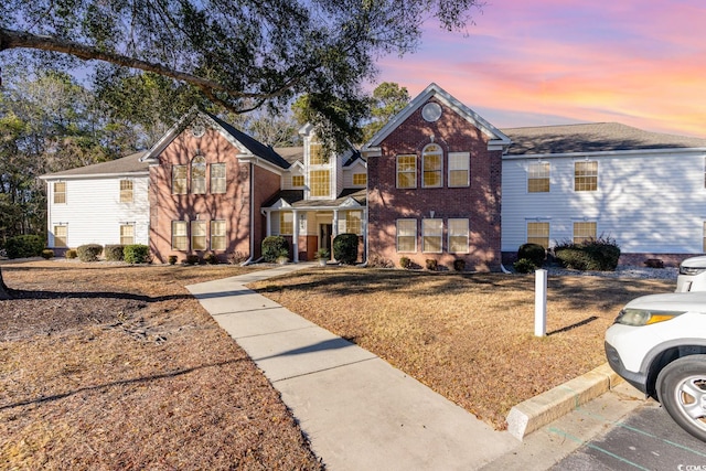 4384 Daphne Ln Unit H, Murrells Inlet, SC 29576 - traditional-style home with brick siding and a lawn