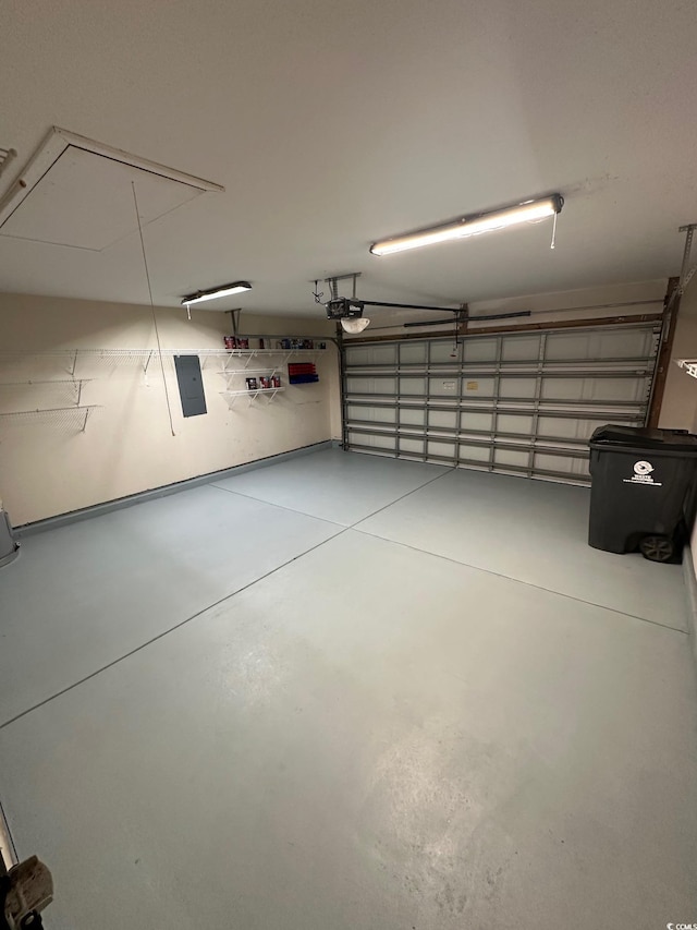 garage with a garage door opener and electric panel