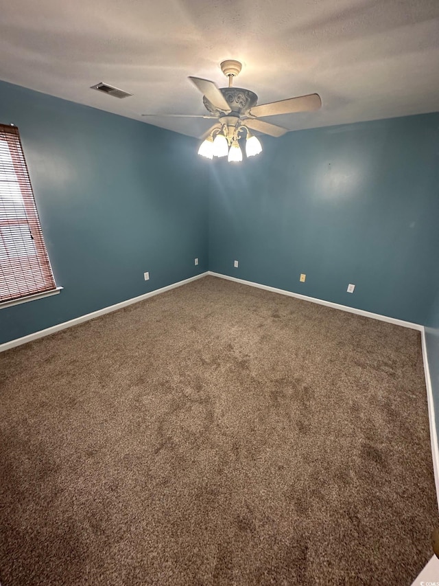 carpeted empty room featuring ceiling fan