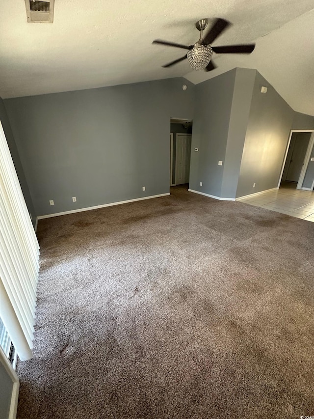 empty room featuring vaulted ceiling, carpet, and ceiling fan