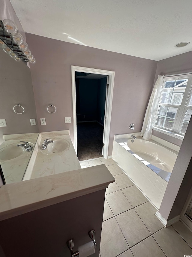 bathroom with tile patterned flooring, vanity, and a tub to relax in