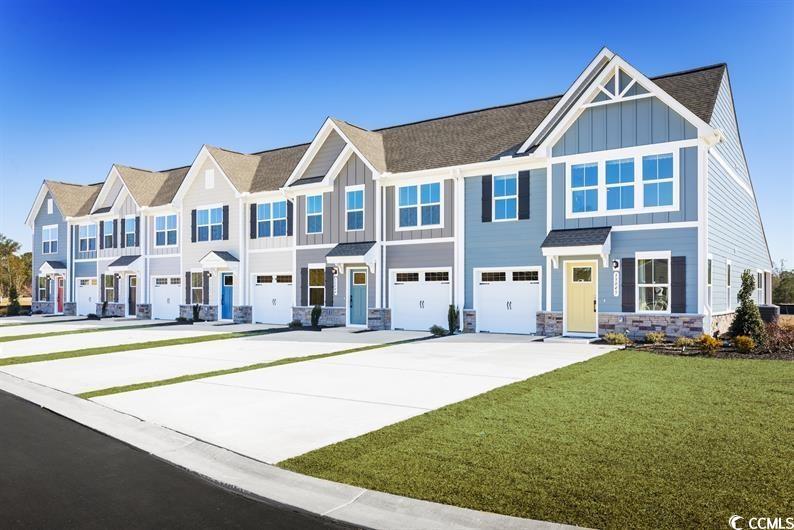 view of front of property featuring a garage and a front lawn