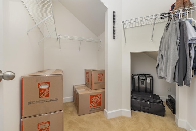 walk in closet featuring light carpet