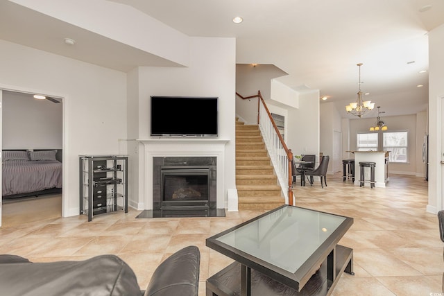 tiled living room featuring a notable chandelier