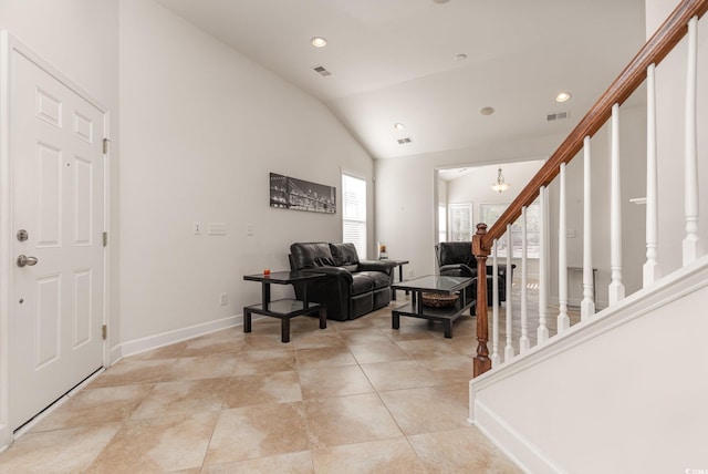 entryway with an inviting chandelier and vaulted ceiling