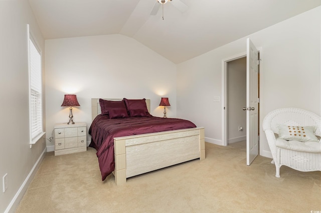 bedroom with ceiling fan, light colored carpet, and lofted ceiling