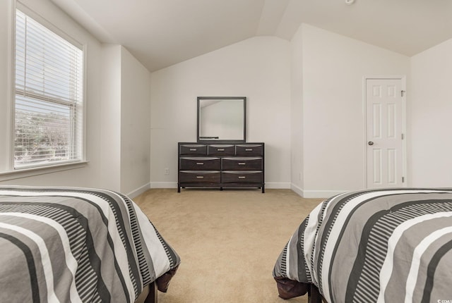 carpeted bedroom featuring multiple windows and vaulted ceiling