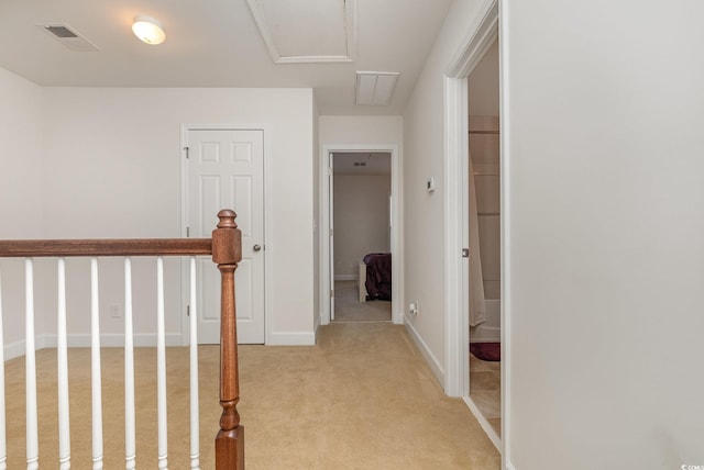 hall featuring light colored carpet