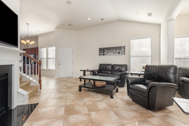 living room with vaulted ceiling, a chandelier, and plenty of natural light