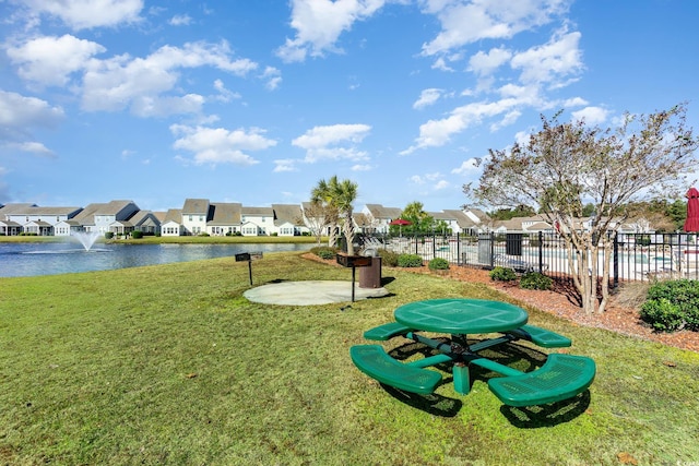 view of community with a water view and a yard