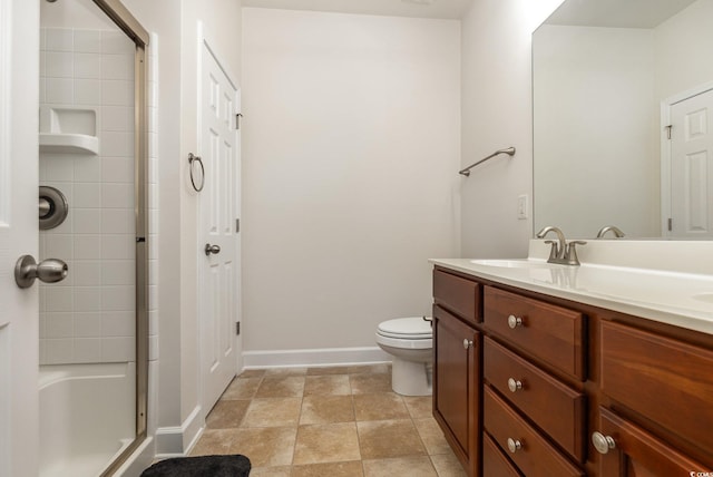 bathroom with toilet, an enclosed shower, and vanity