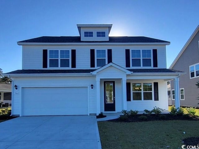 view of front property featuring a garage and a front lawn