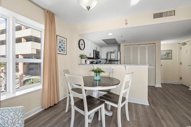 dining room with dark hardwood / wood-style flooring