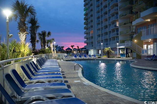 view of pool at dusk