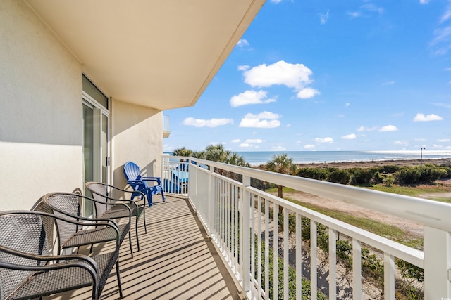 balcony featuring a water view and a view of the beach