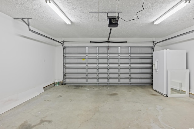 5933 Rahnavard Blvd, Myrtle Beach, SC 29588 - garage featuring a garage door opener and white fridge with ice dispenser