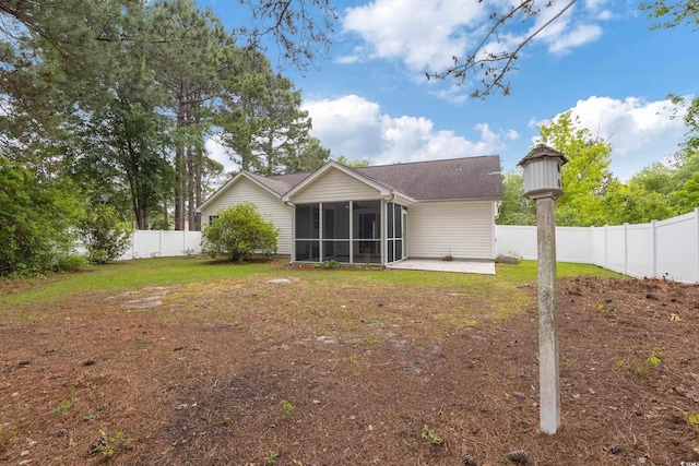 5933 Rahnavard Blvd, Myrtle Beach, SC 29588 - rear view of property featuring a sunroom, a lawn, a fenced backyard, and a patio area