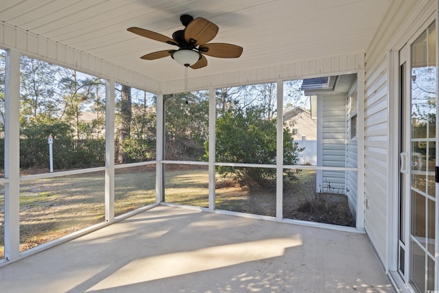 unfurnished sunroom with ceiling fan