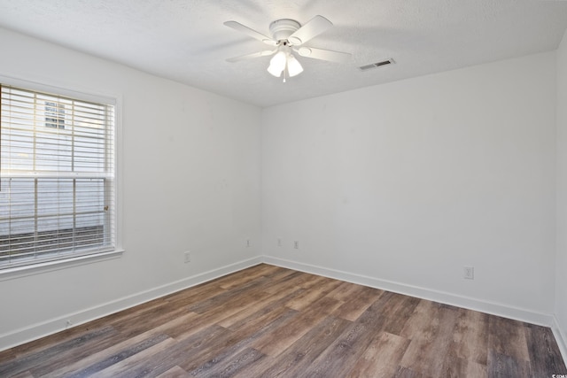 5933 Rahnavard Blvd, Myrtle Beach, SC 29588 - empty room featuring wood finished floors, ceiling fan, baseboards, visible vents, and a textured ceiling