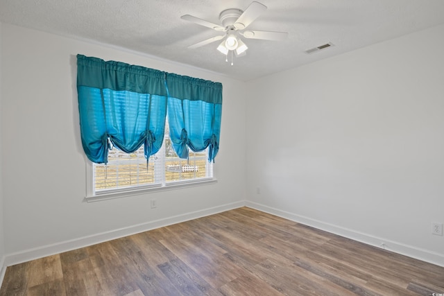 5933 Rahnavard Blvd, Myrtle Beach, SC 29588 - empty room with a ceiling fan, visible vents, wood finished floors, and baseboards