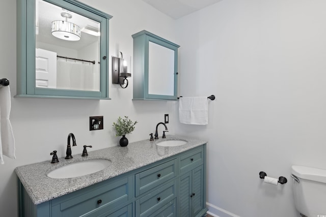 bathroom featuring vanity and toilet