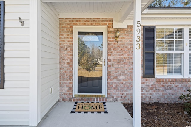 5933 Rahnavard Blvd, Myrtle Beach, SC 29588 - doorway to property featuring covered porch and brick siding