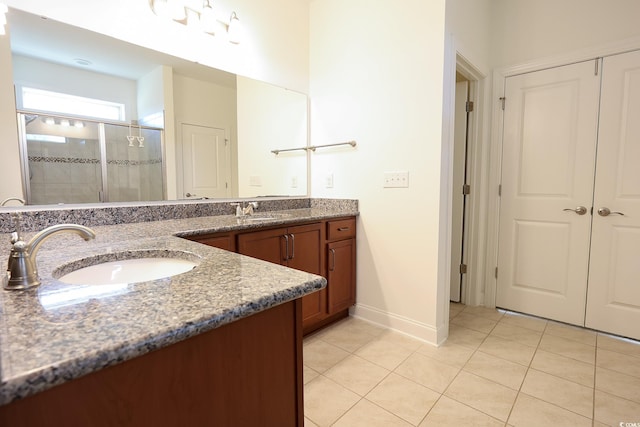 bathroom featuring walk in shower, tile patterned floors, and vanity