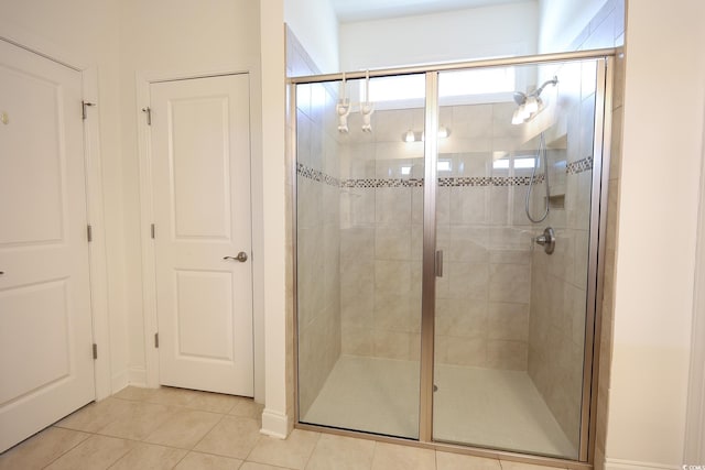 bathroom featuring an enclosed shower and tile patterned flooring