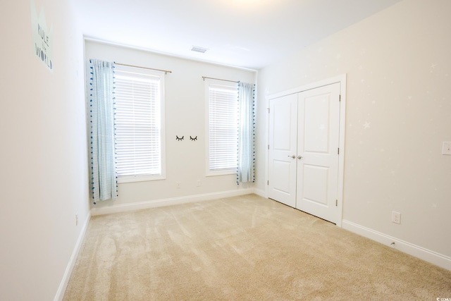 unfurnished room with light carpet