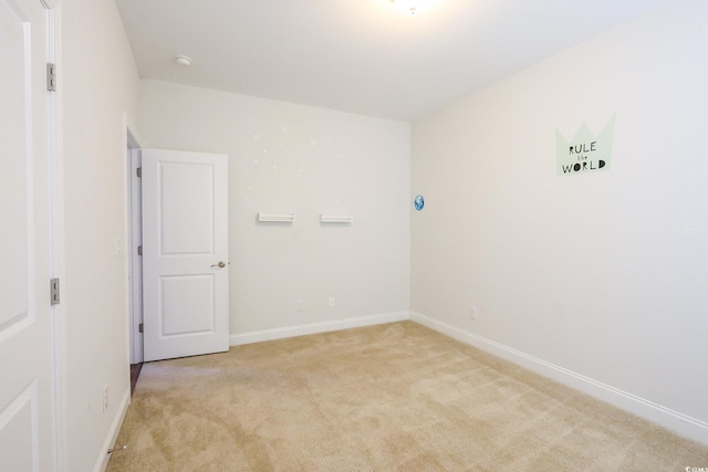 unfurnished room featuring light colored carpet