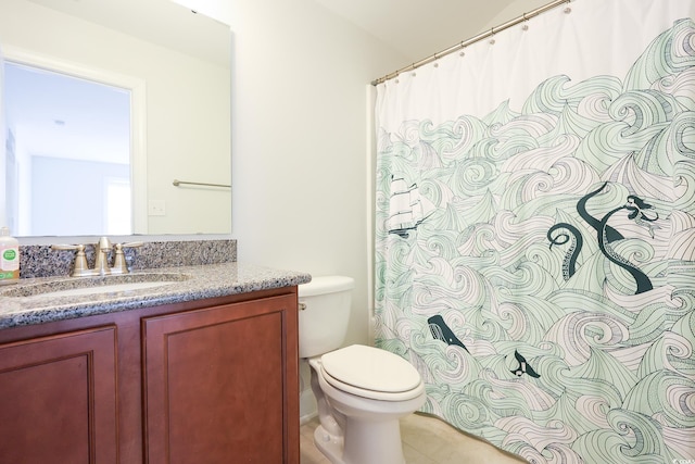 bathroom with vanity, tile patterned floors, and toilet