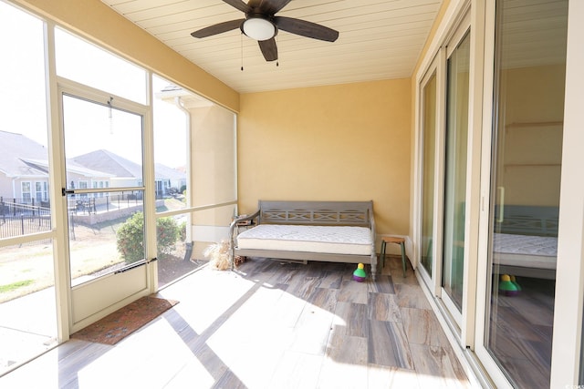 sunroom / solarium featuring wood ceiling and ceiling fan