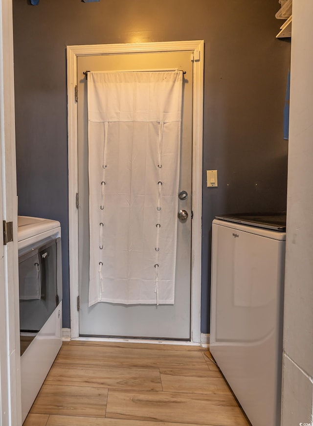 entryway with light wood-type flooring and washer / clothes dryer