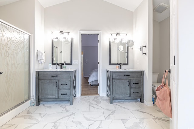 bathroom featuring toilet, lofted ceiling, walk in shower, and vanity