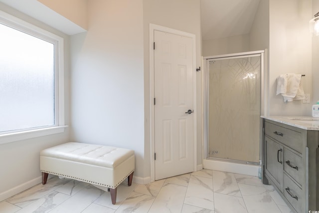 bathroom with a shower with shower door and vanity