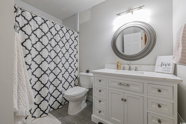 bathroom with toilet and vanity