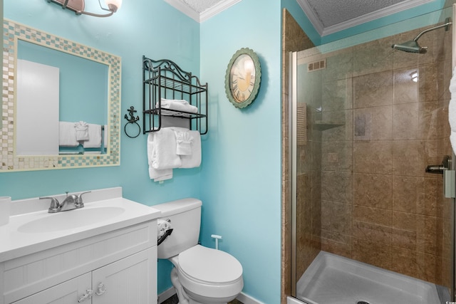 bathroom featuring ornamental molding, vanity, toilet, a shower with door, and a textured ceiling