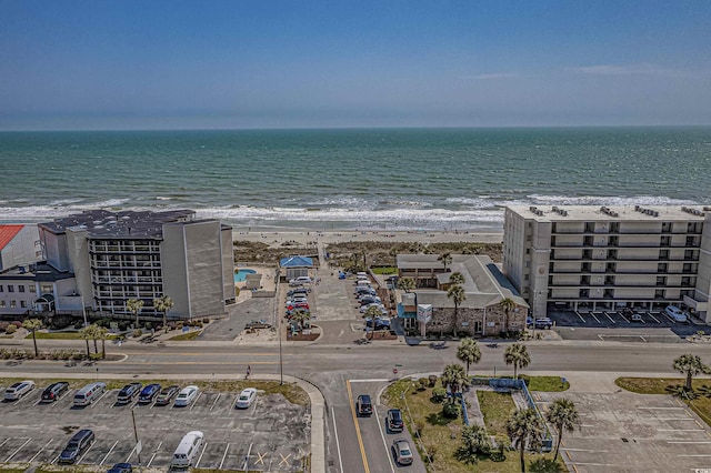 birds eye view of property with a water view and a view of the beach