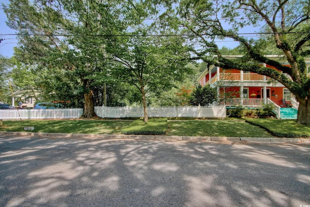 view of yard with a balcony and a porch